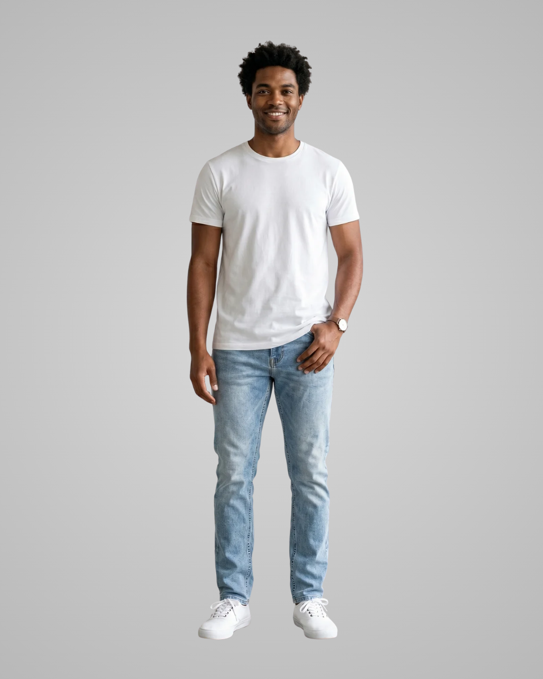 Man wearing a plain white t-shirt and light blue jeans on a gray background