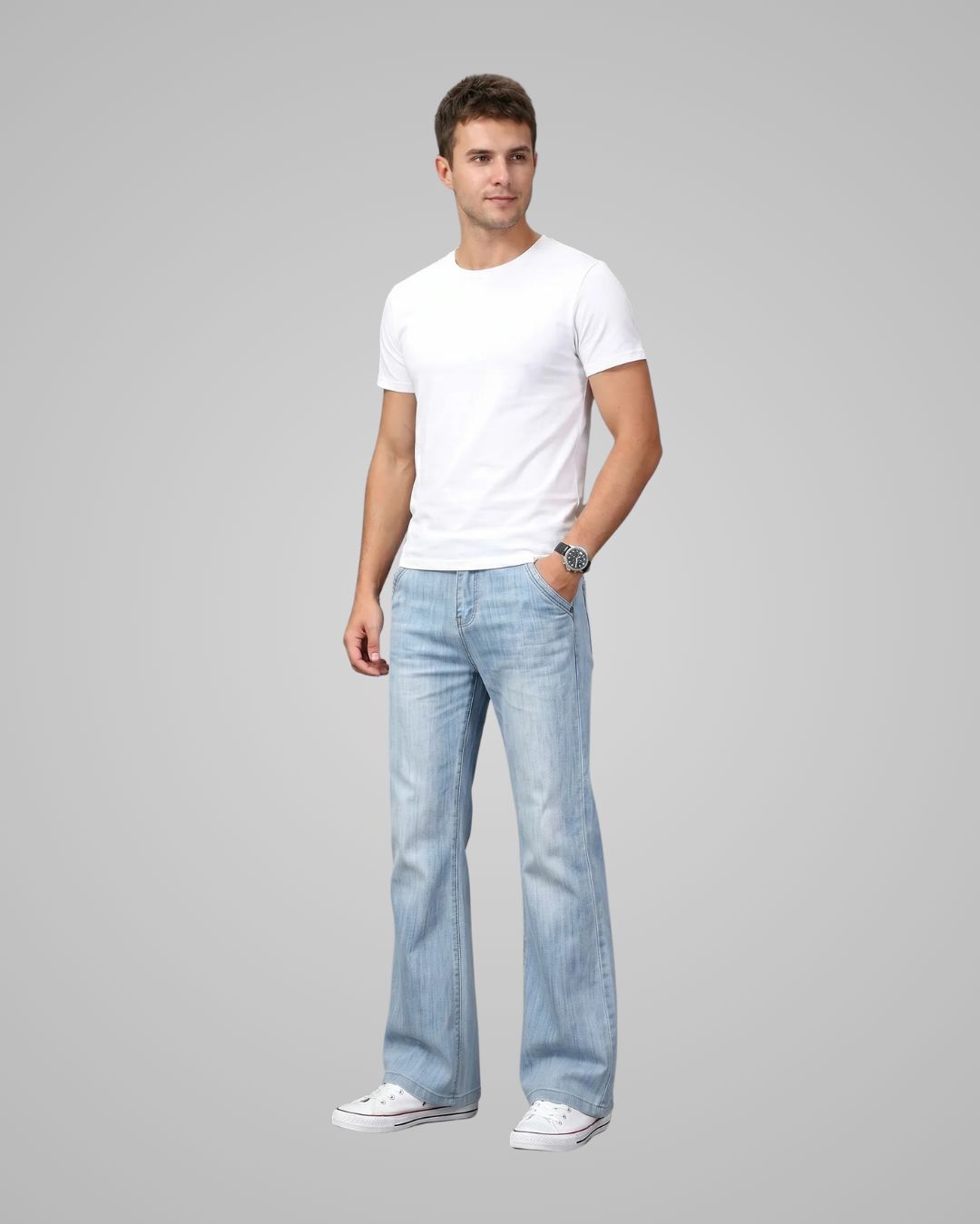Man wearing a white t-shirt and light blue jeans on a gray background