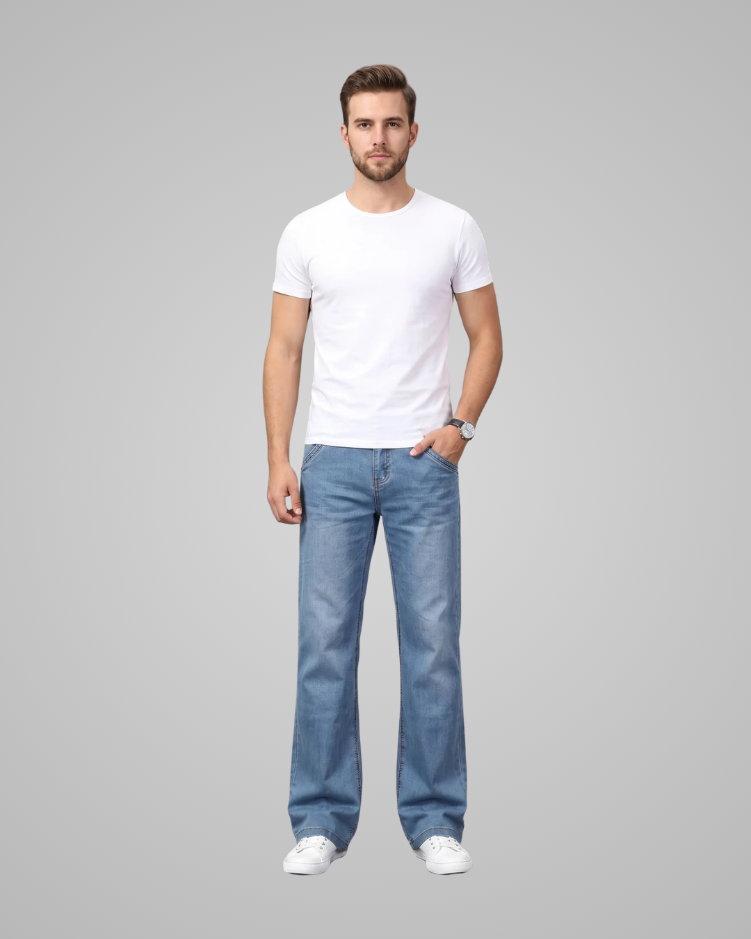 Man wearing a white t-shirt and blue jeans on a gray background
