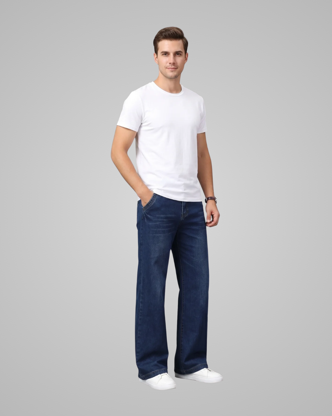 Man wearing a white t-shirt and blue jeans on a gray background