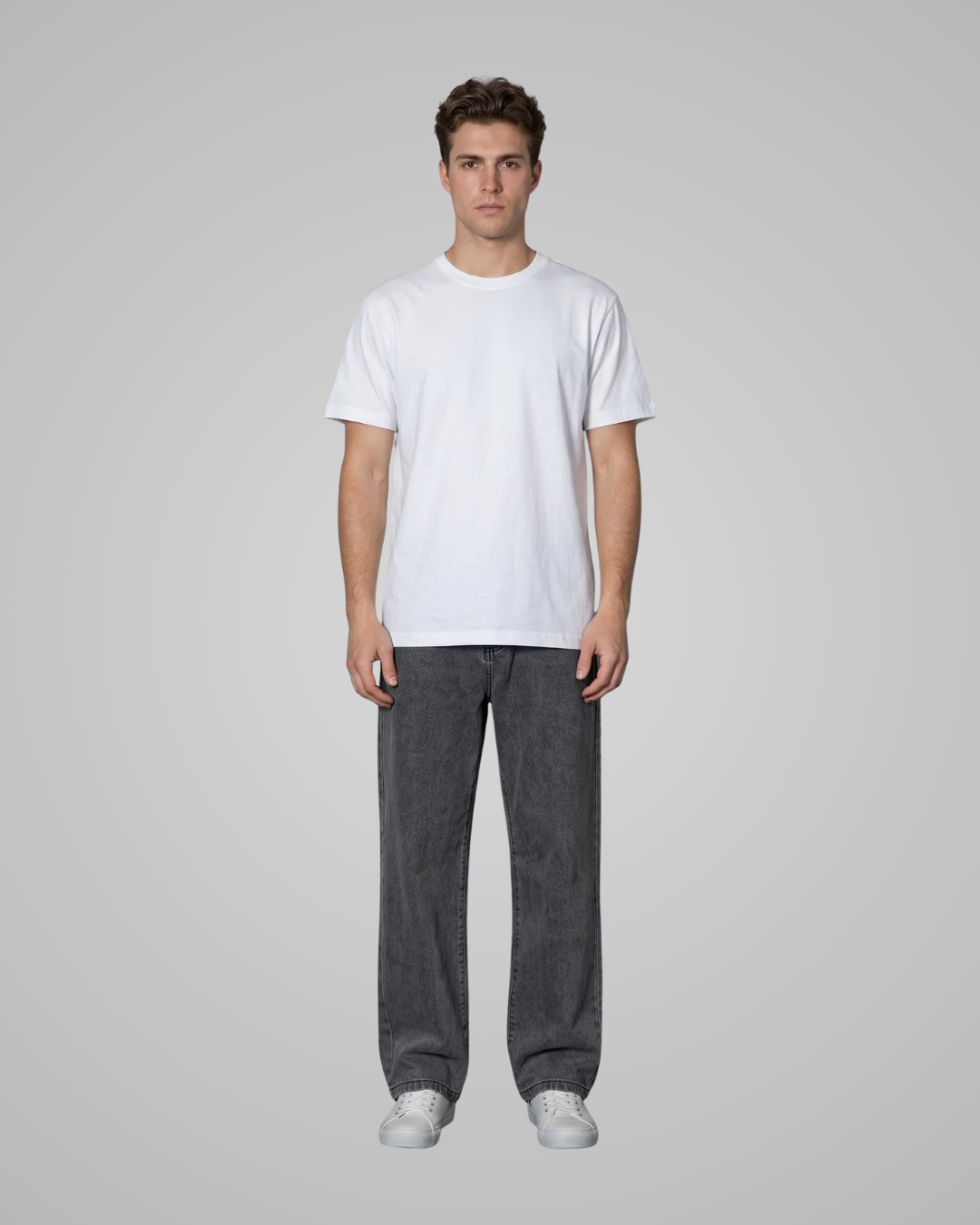 Person wearing a plain white t-shirt and dark gray pants on a light gray background